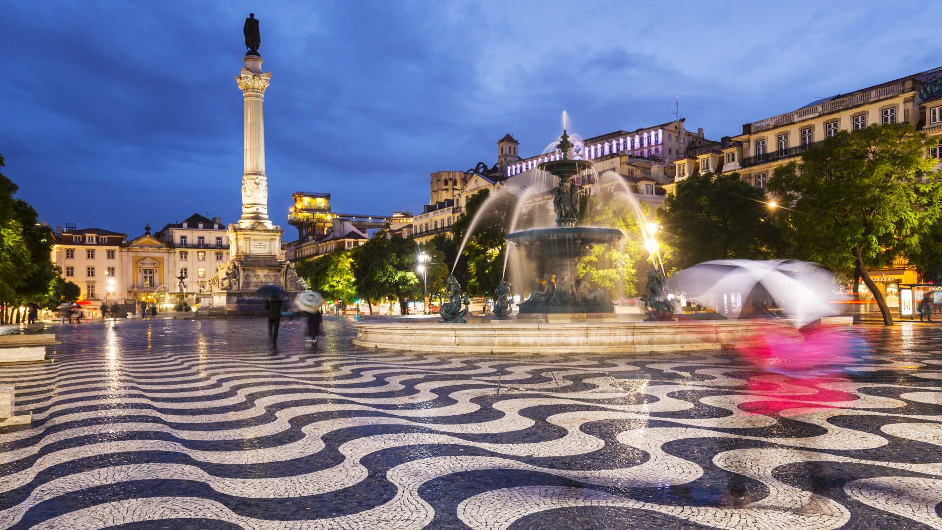 Rossio Square at night, featuring the Column of Pedro IV and the South Fountain