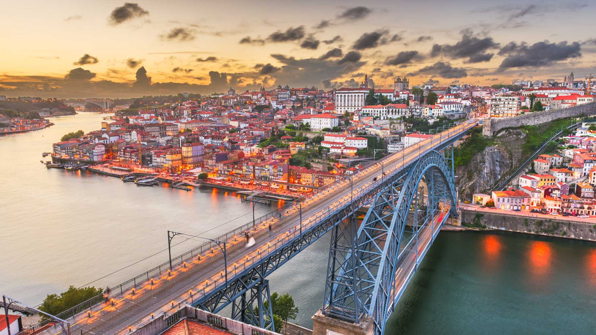 Porto skyline featuring the Dom Luís I Bridge over the Douro River.