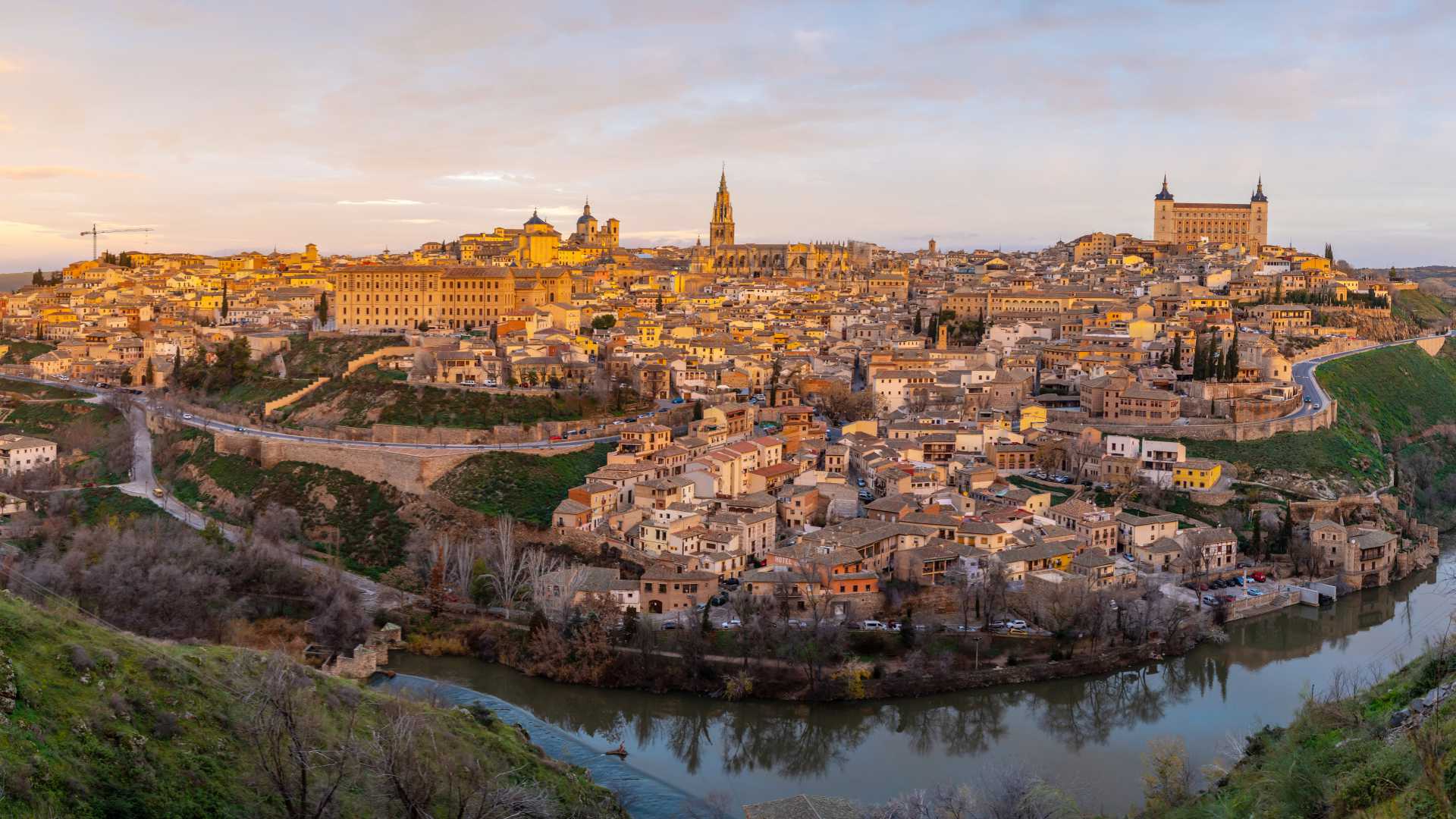 Zonsopgang verlicht de middeleeuwse stad Toledo, met het Alcázar en de kathedraal van Toledo in zicht, Spanje.